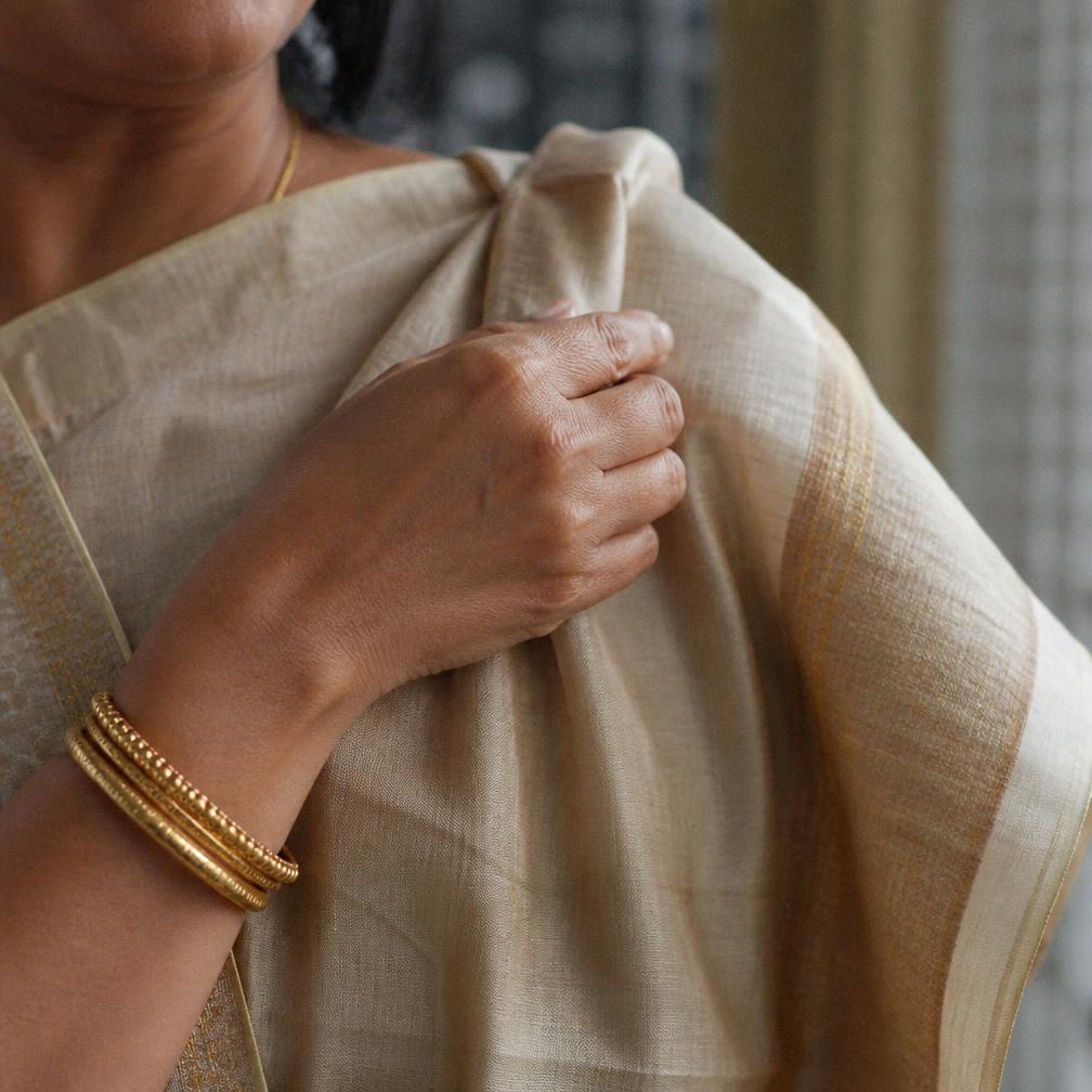 Woman in a terracotta Kosa silk saree during a festival
